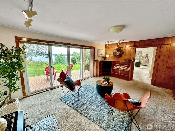 4403...Charming family room features knotty pine accent wall with built-ins, wood burning stove, and large slider with double doors for easy deck and yard access.