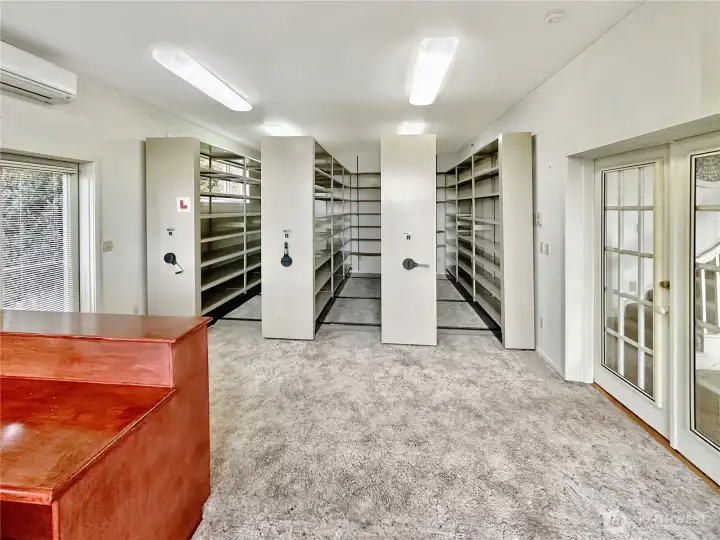 4403...Main floor library with French doors that open to the living room, desk area with more bookcases and territorial and water views.