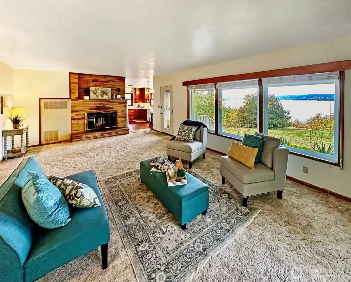 4407...Charming living room with wood burning fireplace and large windows where you will enjoy the views of the changing weather, sunsets and boat traffic.