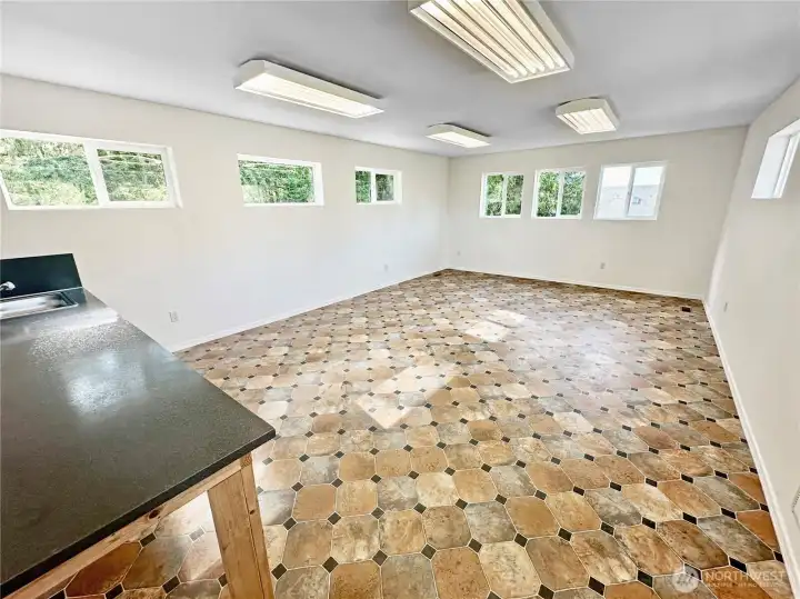 The detached garage features an upper floor office/craft room and/or storage space with utility sink.