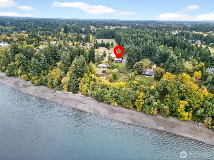 Aerial view shows main house, 2nd house, detached garage/shop/office and pasture area.