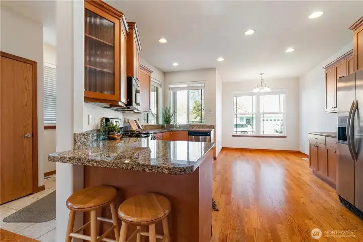 From the open living room, head up to the Peninsula Bar for a cup of coffee, a bite of breakfast, or a cozy place to catch up. The glass-front corner cabinet offers a beautiful way to showcase your favorite bowls, glassware, or decorative accents.