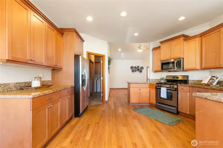 Plenty of cabinets allows for ample storage for all your large kitchen appliances.  Door past the refrigerator leads you to the laundry room and garage.