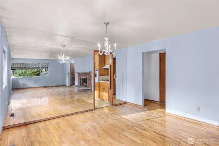 Mirror wall and entry to kitchen with saloon doors.