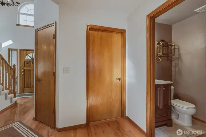 Hallway leading to the powder room and living room.