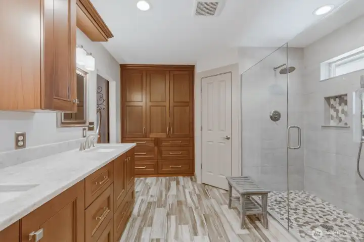 Primary bathroom with tons of storage and walk in closet.