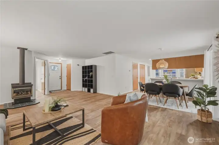 Enter leads into bright and light open living space.  Coat closet to the right.  Built in storage unit stays with home.