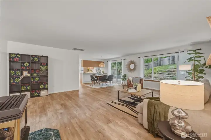 View from hall to living room, dining area and kitchen.