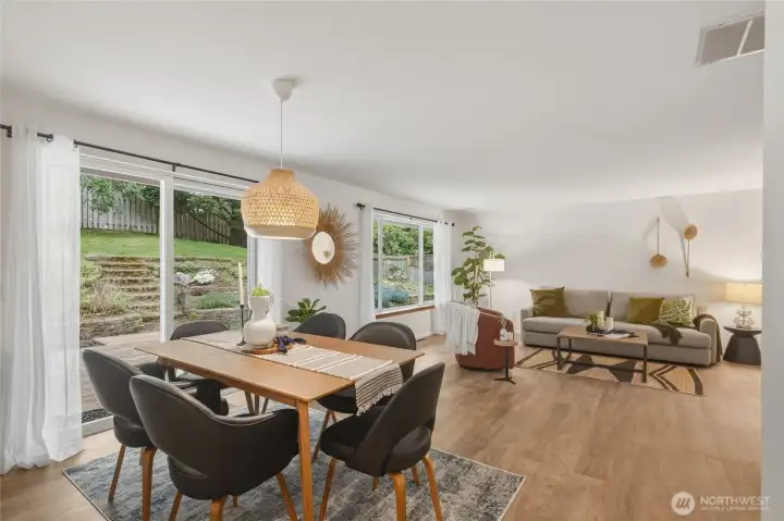 Dining space open to living room and kitchen with sliding door out to deck and fenced back yard.