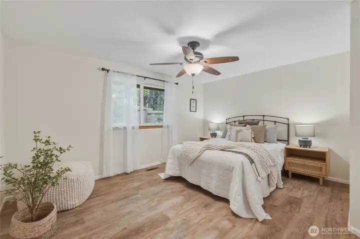 Spacious primary bedroom. New ceiling fan and fresh paint throughout.