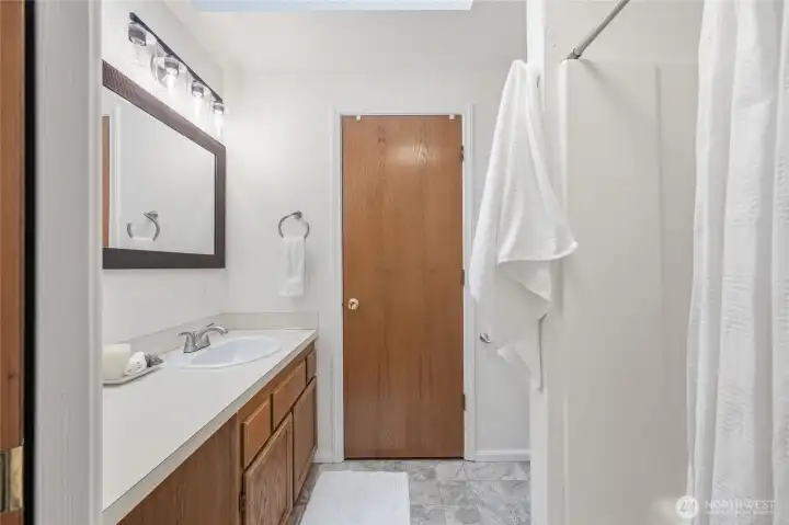 Primary 3/4 bath new flooring, lighting and mirror.