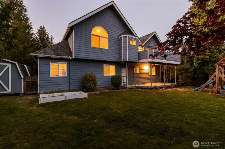 Spacious back yard with 2 sheds to the side, play structure and garden beds. Spacious back yard with 2 sheds to the side, play structure and garden beds.