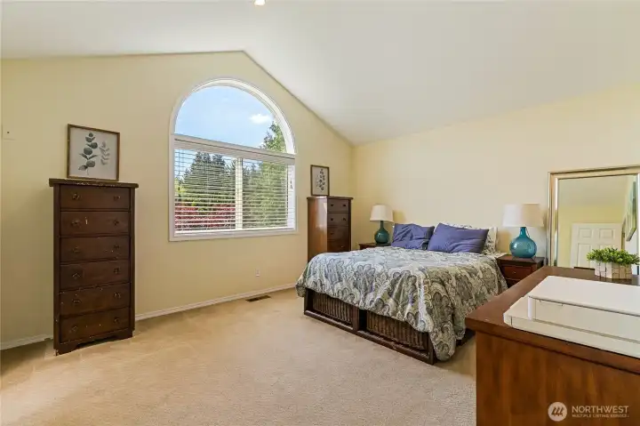 Primary bedroom with vaulted ceiling Primary bedroom with vaulted ceiling