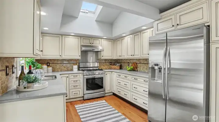 The remodeled kitchen features quartz countertops and stainless steel appliances.