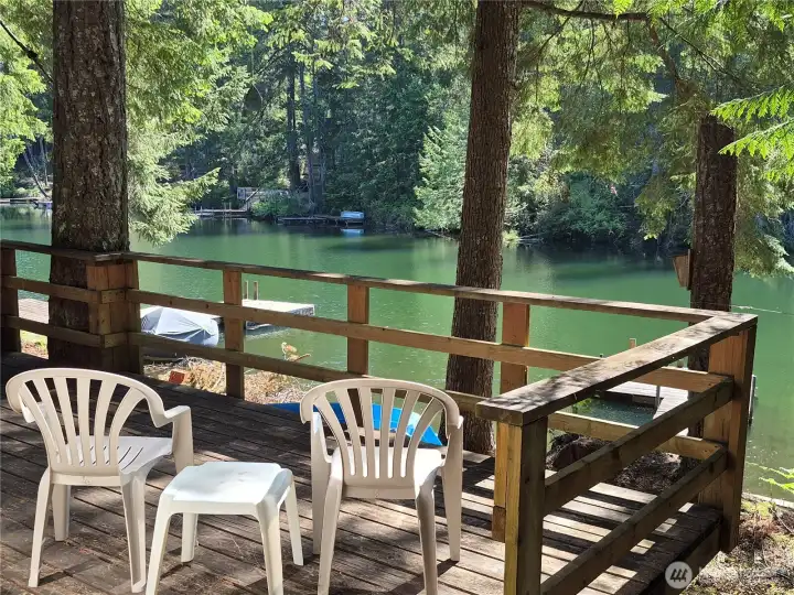 Enjoy the serene views from the large picture windows,  entertaining deck,  or the peace & quiet from the dock.