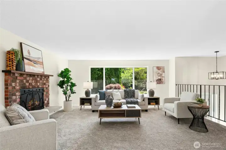 Main level living space with wood burning fireplace, large window with view of landscaping. New wall-to-wall carpeting. Main level living space with wood burning fireplace, large window with view of landscaping. New wall-to-wall carpeting.