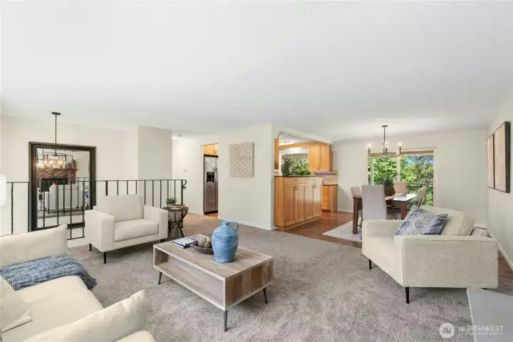 Open Living/Dining/Kitchen space, green views.