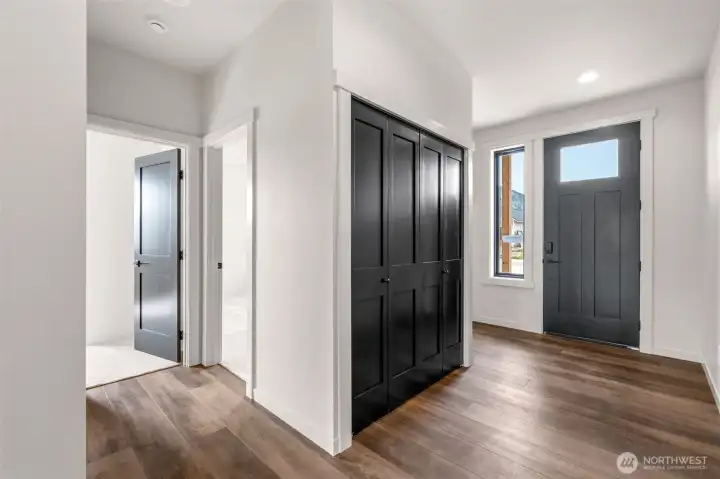 Entry with coat closet and natural lighting.