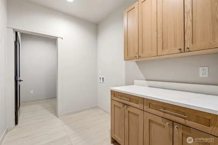 Mudroom leading in from the spacious 2+ car garage for laundry and additional storage.