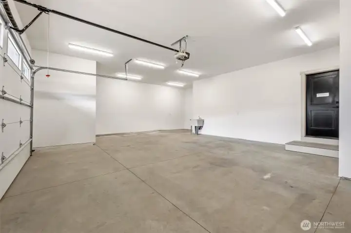 Spacious 2+ car garage with extra space for a shop.