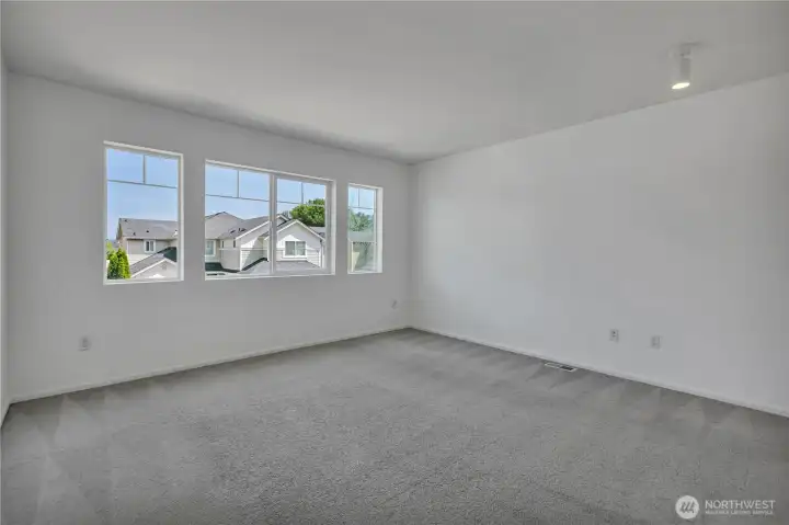 Bedroom 2 with a wall of windows. Faces the front of the home. Large closets behind this shot. Bedroom 2 with a wall of windows. Faces the front of the home. Large closets behind this shot.