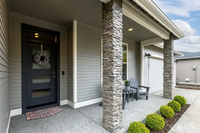 The sitting porch and gorgeous front door with reed glass are very welcoming and make quite the statement.