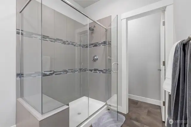 There is a lovely over-sized, tile shower that has low clearance to step into.