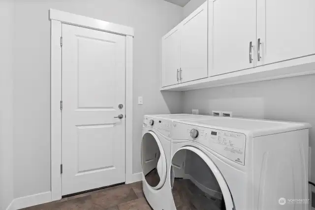 The laundry room opens to the garage and is near the primary suite.