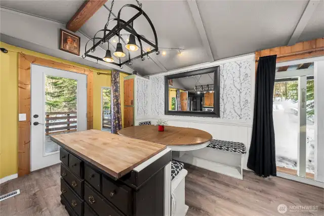 ADU kitchen & dining room with door leading to private deck
