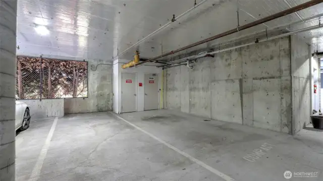 Two Large side by side secured garage spots with a storage unit around the corner too.