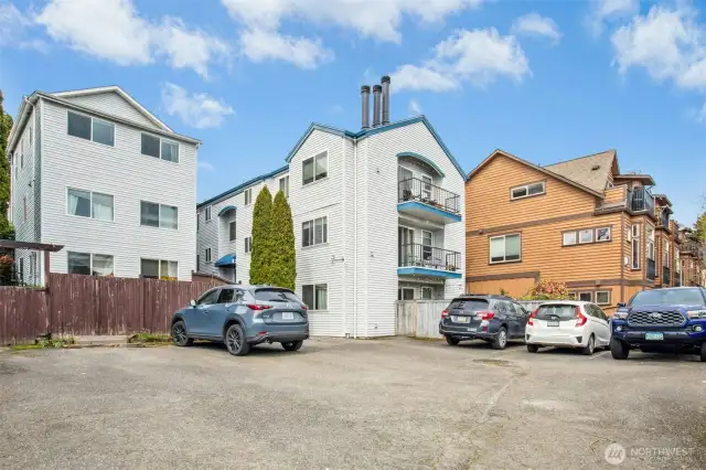 Back of building, parking area.