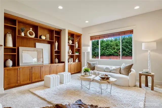 Relax in the family room with serene views through large windows overlooking the yard.