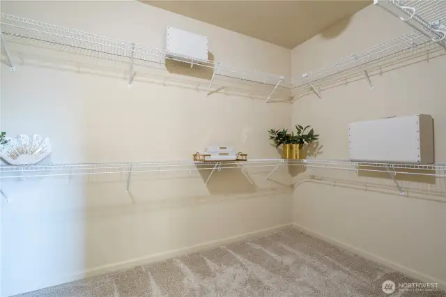 Expansive walk-in closet with ample shelving and storage.