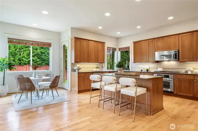 Gourmet kitchen with a large granite island and elegant cabinetry, ideal for cooking and entertaining