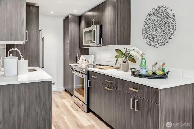 Featuring quartz countertops, subway tile backsplash, cool cabinetry with full extension pull-out drawers and premium appliances, for both style and functionality.
