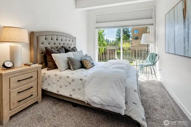 The delightful bedroom features a large walk-in closet and large sliding glass door that opens to a charming private balcony.