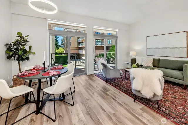 Soaring 10-foot ceilings, luxury vinyl plank flooring, and abundant western light create an airy, sophisticated ambiance.