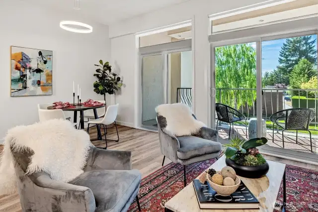 Two sets of sliding glass doors with clerestory windows expand the living space, inviting in natural light and the lush greenery outdoors.