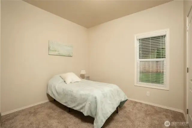 Bedroom #3 facing backyard, with larger closet where the water heater is located.