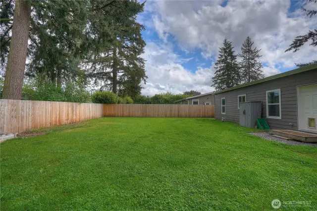 Another view of the backyard looking to the South. Garden storage is included, and on the right you will see the back door entry with a pet entry.