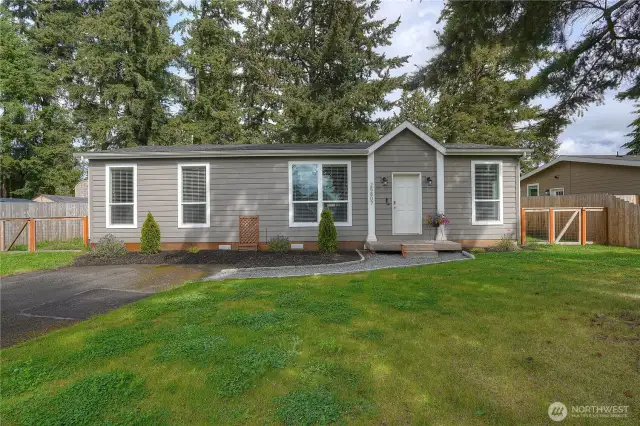 Another view of the large front yard with perimeter fencing and cross fencing enclosing the entire backyard.
