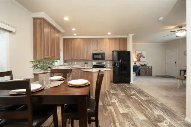 View of dining area flowing into kitchen and living room.