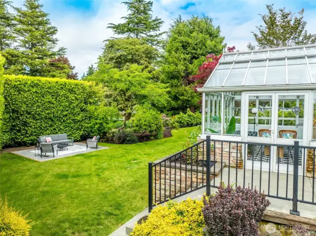 Incredible conservatory is a lovely addition to this gorgeous home. Pre-plumbed gas line for a gas fireplace. Ceiling canters open and is an operable greenhouse.