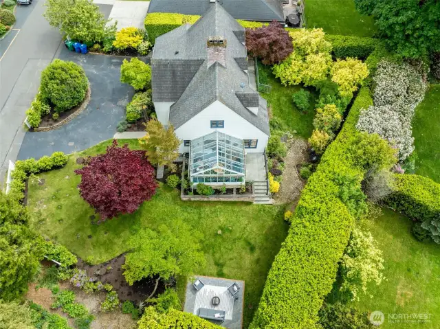 Large, level, manicured lot with mature landscaping and fruit trees.