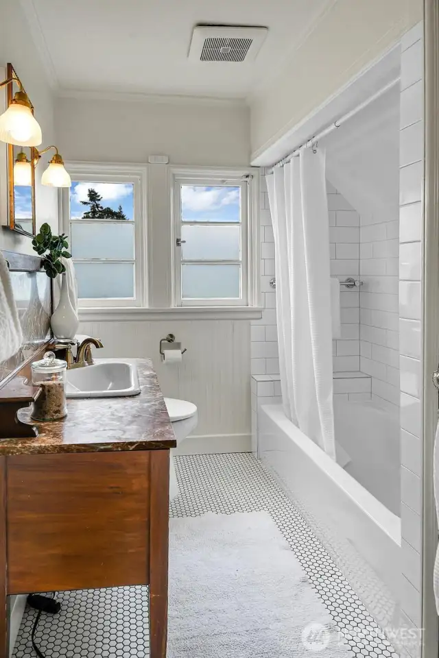 Second floor full bathroom has exquisite period details and a functional layout.