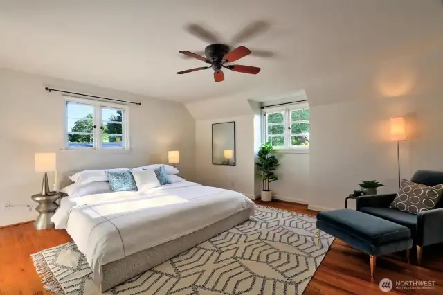 Huge primary bedroom with walk-in closet, stunning view, and glowing natural light.