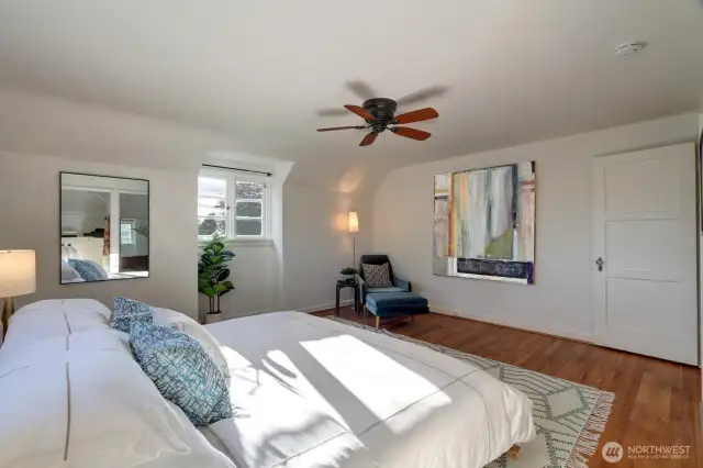 Huge primary bedroom with walk-in closet, stunning view, and glowing natural light.