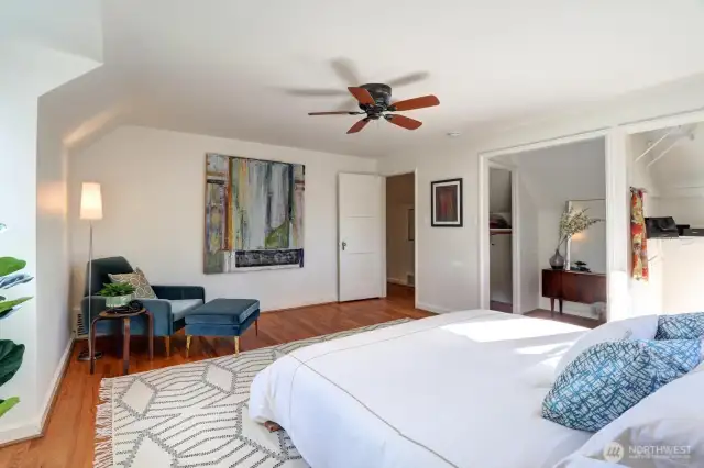 Huge primary bedroom with walk-in closet, stunning view, and glowing natural light.
