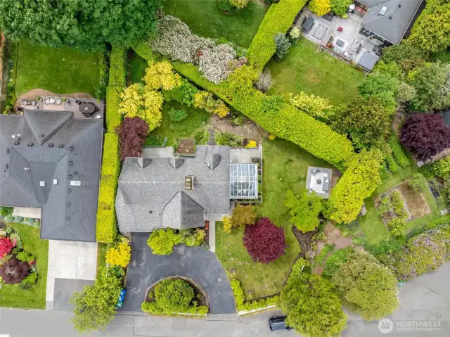 Large, level, manicured lot with mature landscaping and fruit trees.