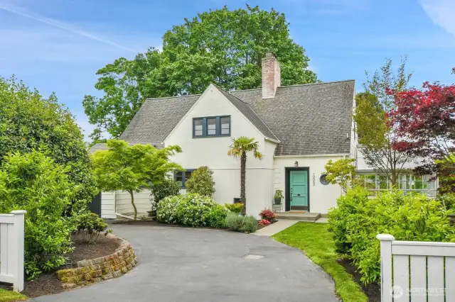 Stately manicured lot with circular driveway.